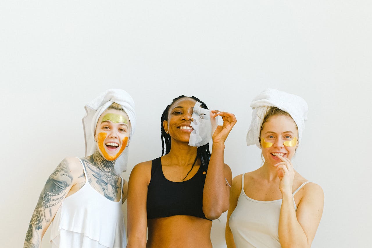 Happy women with mask and eyes patches on face